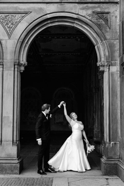 A couple kiss on the waterfront in DUMBO on their wedding day.