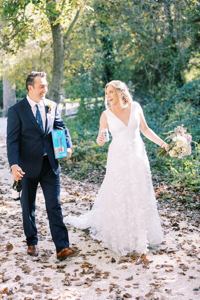 Bride and groom laughing and walking