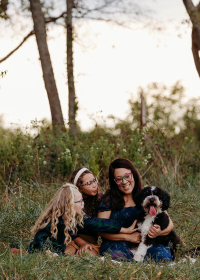 Family petting dog during photoshoot in Franklin Tennessee,