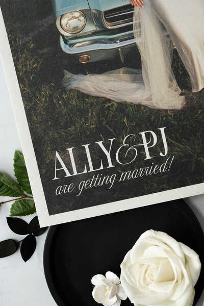 White menu card on a plate with a brown velvet napkin and flowers