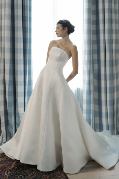 A-line gown of Faille-Back Satin with dramatic extended train and buttons to the hem
