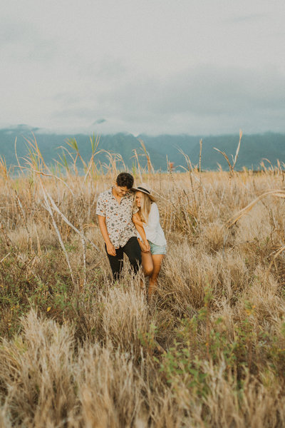 man & woman standing in field