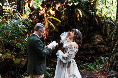 couple laughing while sharing wedding vows