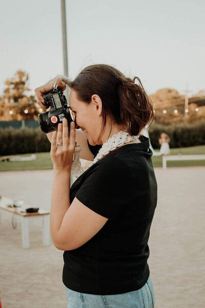 Side profile of Emme Jae Photography taking photo and laughing