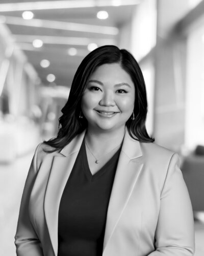 Woman with dark hari in light colored blazer Vice president Administration