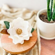 Close up of a Modern magnolia Sugar flowers On a two tier cake