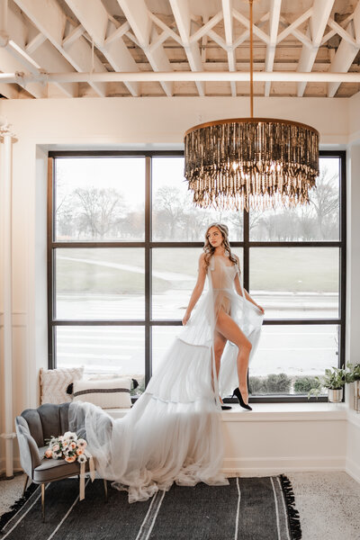 milwaukee bride shows some leg in the large window at the Denizen