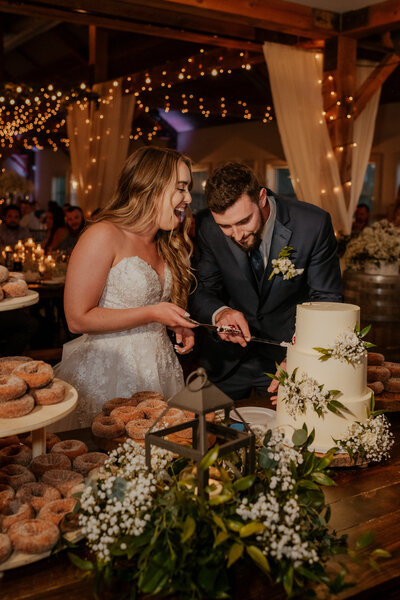 bride and groom cutting the cake at their wedding