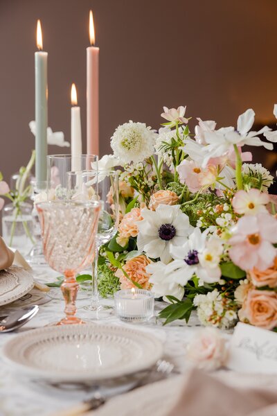 romantic wedding table setting with pastel florals, taper candles, and delicate glassware for an intimate celebration
