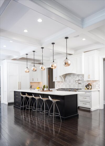 Dark wood dining table with light chairs and flower feature