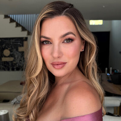Bride with dewy natural glam makeup and loose curls at Madonna Inn