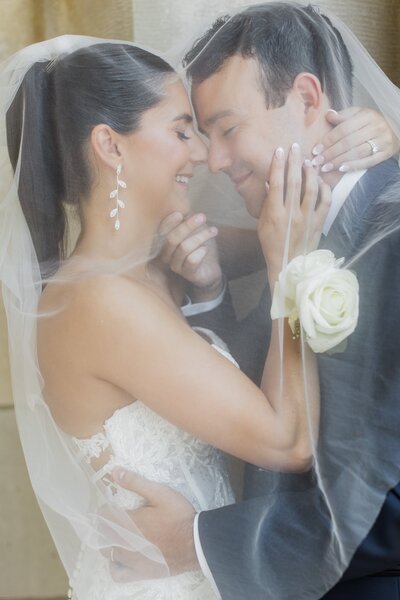 Bride and groom under veil at sea cliff manor long island new york wedding