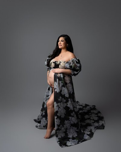 Black and gray floral gown with long sleeves and open belly styling