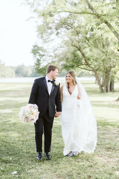 A bride and groom walking at dodson farms