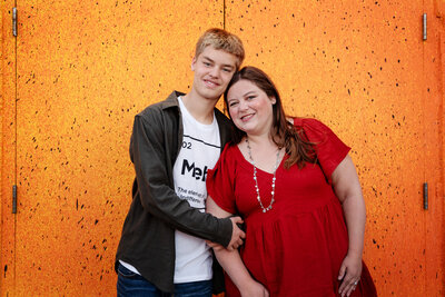 st-louis-mini-sessions-mom-and-teen-son-on-colorful-wall