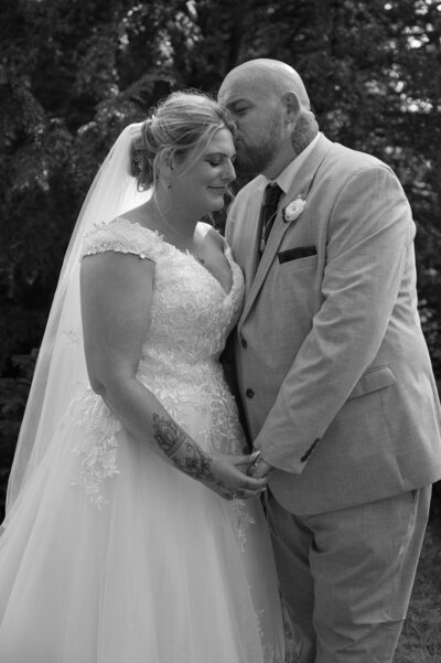 Bride and groom sharing a kiss outside St Mary’s Church, Northwich, wedding photographer
