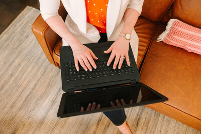 Lindsay typing on a laptop