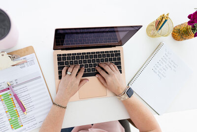 Your Women’s Health Provider at Reforme Wellness uses her pink laptop to empower wellness, texting with a patient to assist with their health journey.