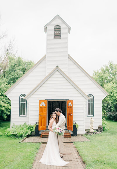 Maple Dell Acres Wedding Venue Bride and Grrom in front of Vintage Wedding Chapel Alberta