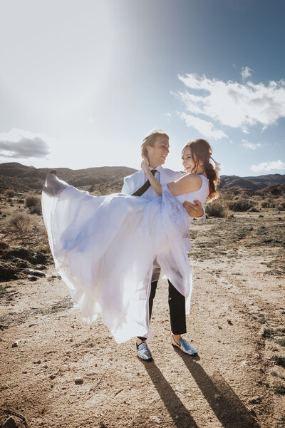 Elopement Photographer,  bride and groom stand before old truck with rock n' roll hand gestures