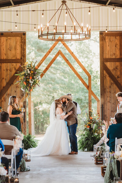 Lacey Nicole Photography at The Rosewood Venue in Mount Vernon Texas Bride and Groom getting married first kiss east texas ceremony
