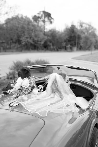 Bride and groom in vintage car at their wedding in Austin Texas