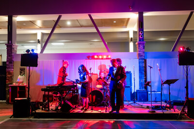 band with neon uplighting at Alpine Ski Club wedding reception