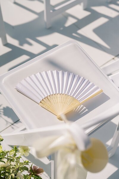 wedding details including flowers and fan to show Helena Elizabeth Events wedding planners in south jersey