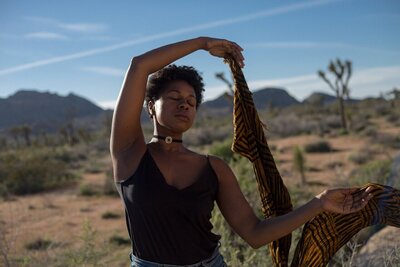 A woman dancing in the desert feeling freer because of healing with chakras