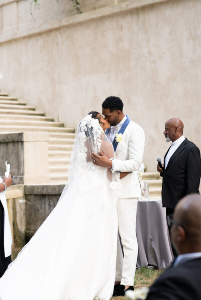 A couple sharing their first kiss at the Swan House in Atlanta, GA