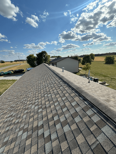 Finished roof against a clear blue sky, installed by Black Bear Roofing & Exteriors.