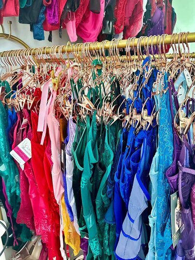 A vibrant display of bras hanging on a rack, showcasing a variety of colors and styles.
