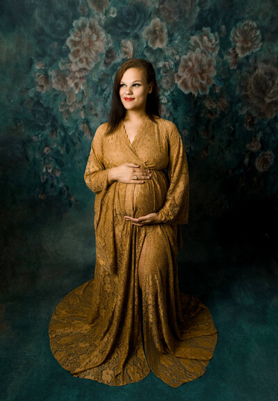 Maternity photo of a mother in a gold  dress at Amy Skarzenski Photography Studio in Erie Pa