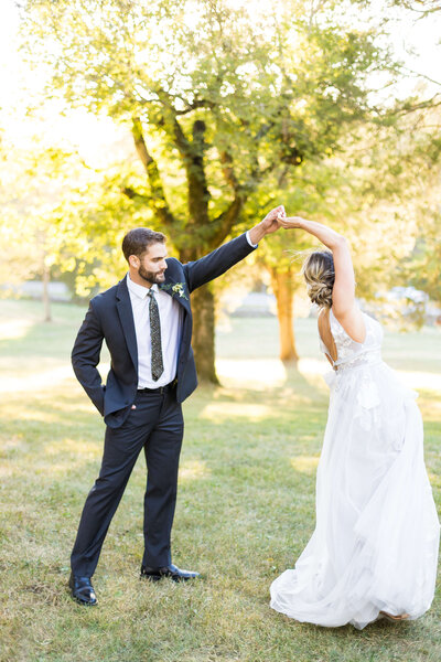 Groom twirling bride around at Tennessee wedding