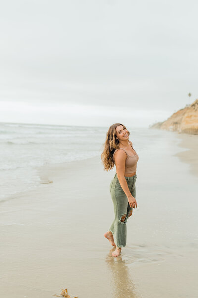 a girl smiling on a beach