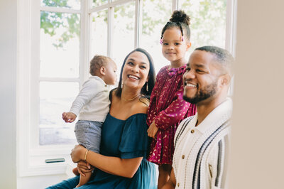family of four sitting in a window