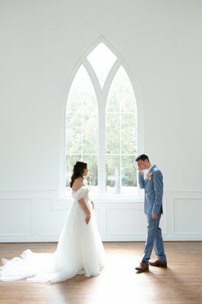 bride and groom first look in chapel