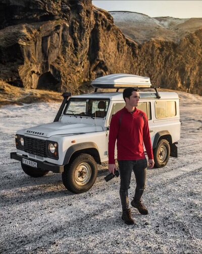man standing by jeep