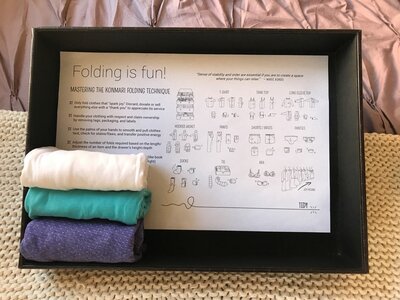 How to fold clothing illustration with three folded t-shirts.