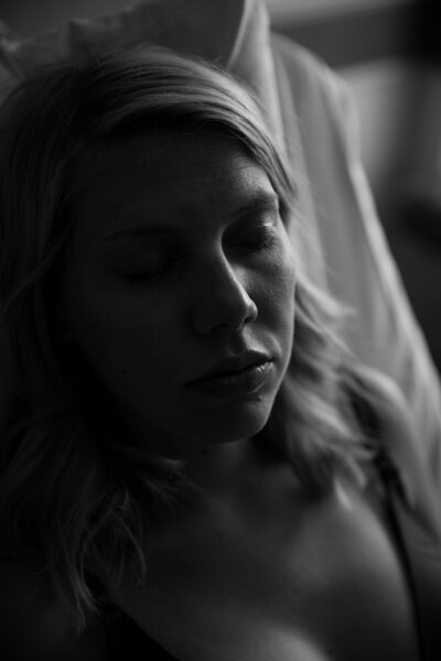 Black and white portrait of an IVF mother lit with window light, captured at Michael Garron Hospital in Toronto during her birth experience.