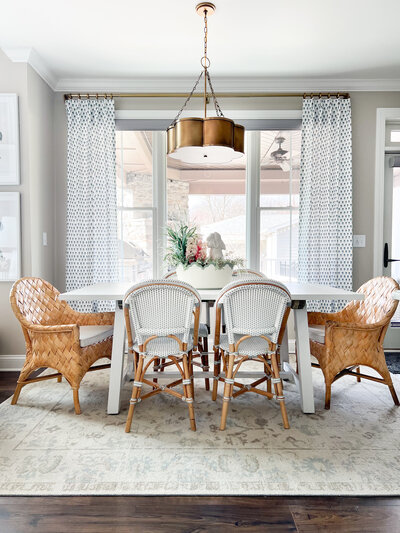 a dining room with wood wicker furniture