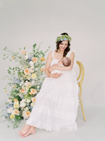 Newborn baby in bassinet flowers Denver Family Photographer