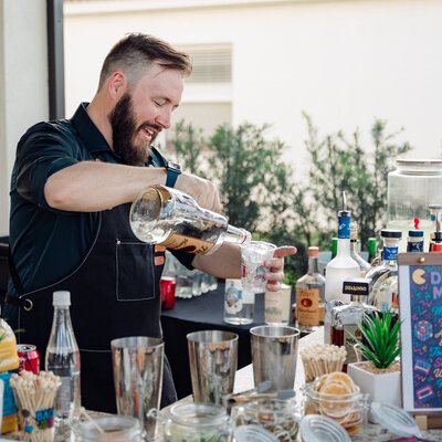 Chris pouring a drink at the bar