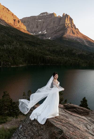 A couple poses in a canoe on their elopement day.