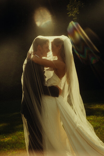 A peasant looking couple in fog walk on a hill with lanters.