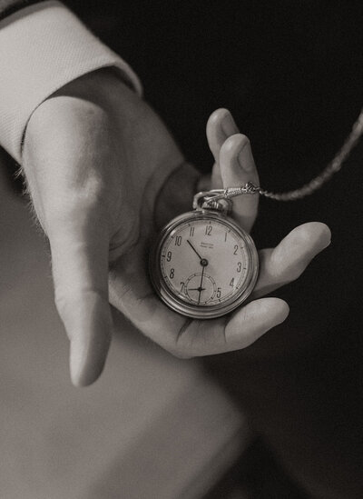 Close up look at someone holding a old pocket watch