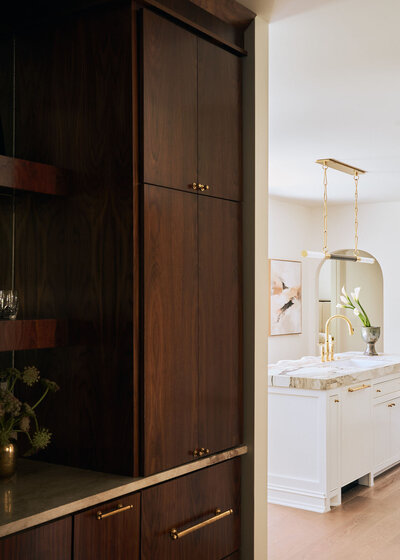 Powder bath with tropical wallpaper green mirror and gold light fixtures