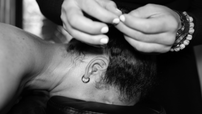 Dr. Nicole Harkness, NYC Acupuncturist prepares to insert ear seed into relaxed patient's ear