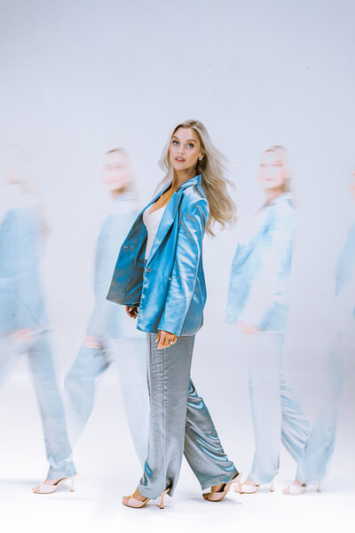 Blonde female model walking across scene. 