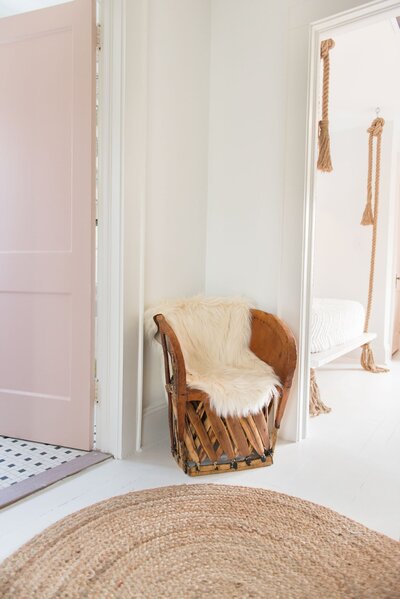 the ultimate boho chair positioned between two walkways with a jute rug in front